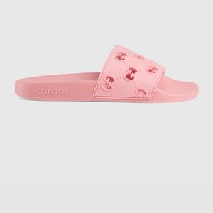 Pink Gucci slides.